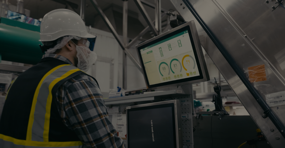 factory worker looking at OEE dashboard